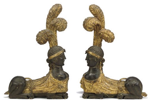 A PAIR OF AUSTRIAN PARCEL-GILT WOOD SPHINXES