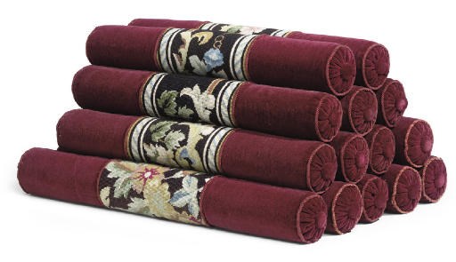 A SET OF EIGHT AND A SET OF SIX RED VELVET AND FLORAL NEEDLEWORK BOLSTERS