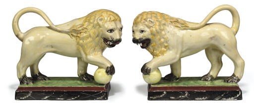 A PAIR OF STAFFORDSHIRE PEARLWARE MODELS OF LIONS