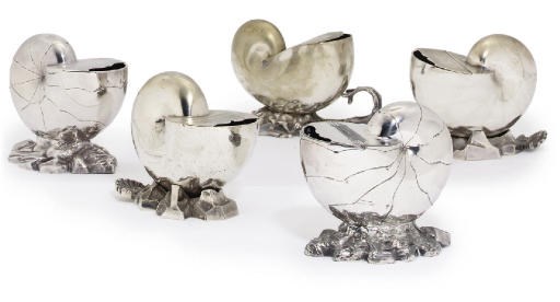 A GROUP OF FIVE VARIOUS SILVER-PLATE AND METALWARE SPOON-WARMERS