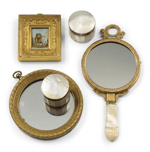 A CHARLES X PALAIS ROYALE ORMOLU AND MOTHER-OF-PEARL HAND MIRROR
