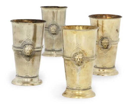 A SET OF FOUR GILT-METAL BEAKERS