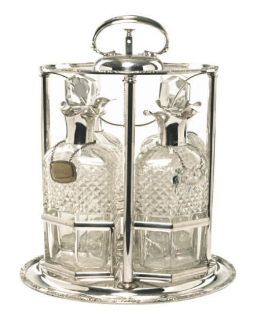 A GEORGE V SILVER AND SILVER-PLATED FOUR BOTTLE TANTALUS