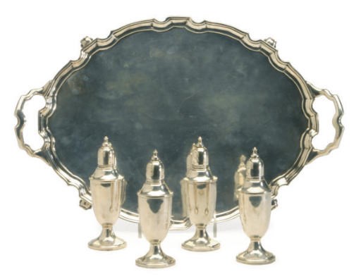 AN AMERICAN SILVER TWO-HANDLED OVAL TRAY AND FOUR PEPPER CASTERS,