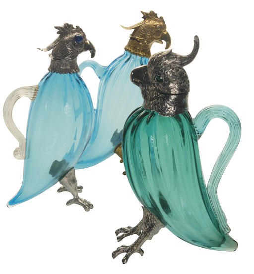 TWO SILVER-MOUNTED GREEN GLASS CLARET JUGS AND A SIMILAR GILT-METAL CLARET JUG,
