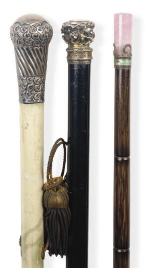 A GROUP OF THREE CONTINENTAL WALKING STICKS,