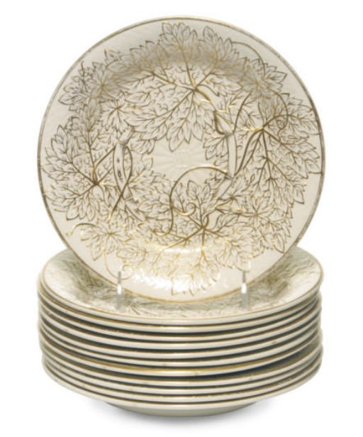 A SET OF TWELVE ENGLISH MOLDED QUEENSWARE GRAPELEAF-MOLDED PLATES,