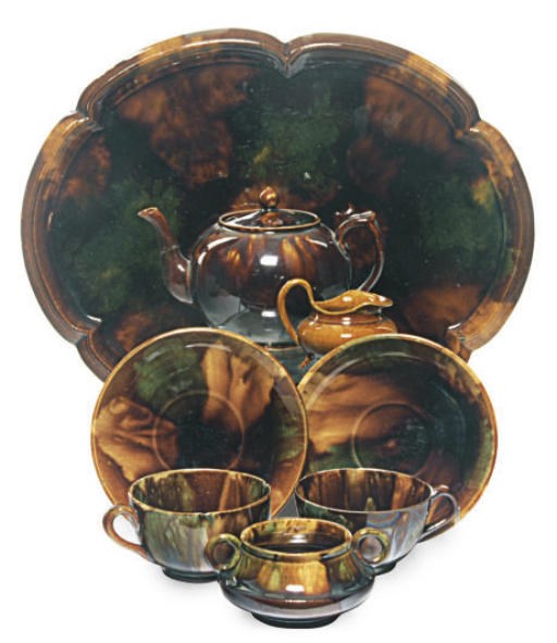 A SCOTTISH EARTHENWARE BROWN FLAMBE GLAZED TETE-A-TETE,