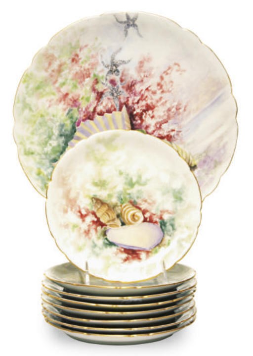 A LIMOGES PORCELAIN SET OF EIGHT PLATES AND A PLATTER PAINTED WITH SEASHELLS,