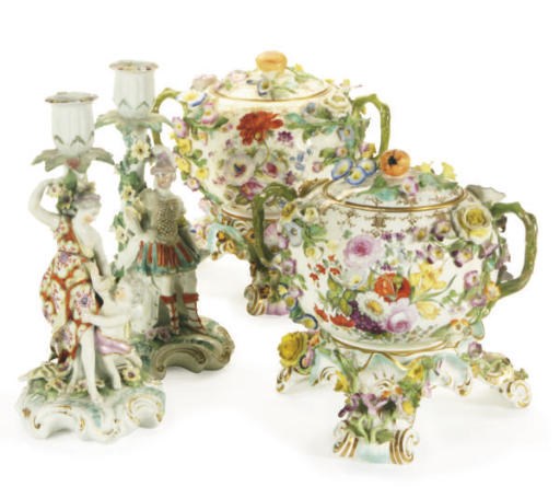 A PAIR OF ENGLISH FIGURAL BOCAGE CANDLESTICKS EMBLEMATIC OF 'WAR' AND 'PEACE' AND A PAIR OF ENGLISH TOPOGRAPHICAL FLOWER-ENCRUSTED TWO-HANDLED BOWLS AND COVERS ON GERMAN FLOWER-ENCRUSTED TREFOIL STANDS,