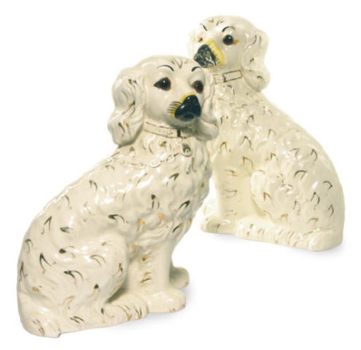 A PAIR OF STAFFORDSHIRE MODELS OF SEATED SPANIELS WITH GLASS EYES,