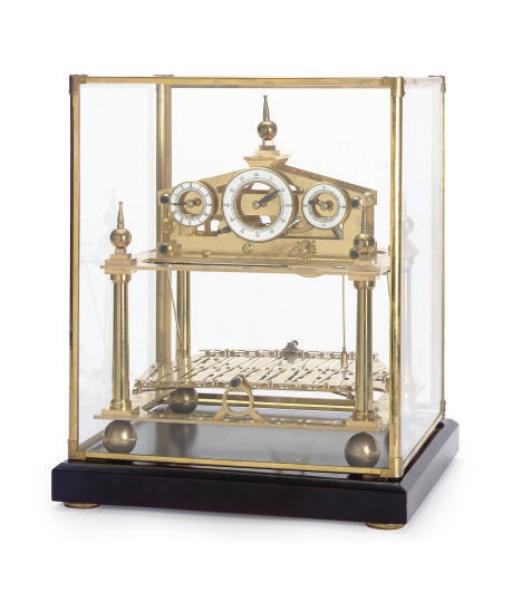 A BRASS AND ENAMEL BALANCE CLOCK WITH GLASS COVER,