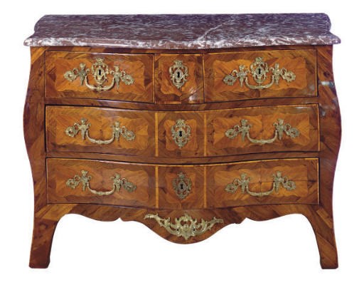 A REGENCE ROSEWOOD AND TULIPWOOD SERPENTINE BOMBE COMMODE**,