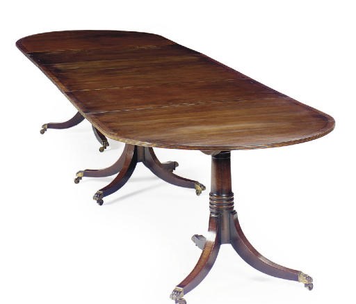 AN ENGLISH EBONY-INLAID MAHOGANY AND CROSSBANDED TRIPLE-PEDESTAL DINING TABLE,