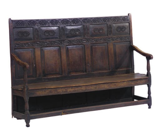 AN ENGLISH CARVED OAK SETTLE,