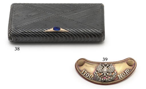 A jewelled gold-mounted gun-metal cigarette-case