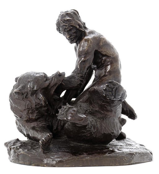 A bronze figure of a man wrestling a bear