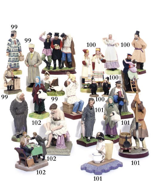 A porcelain figure of a lady at her toilette with four other figures