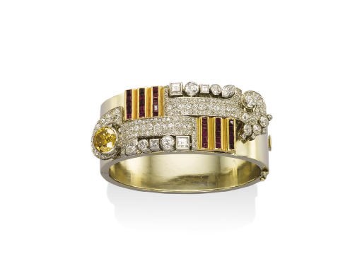 AN ART DECO DIAMOND AND RUBY BANGLE