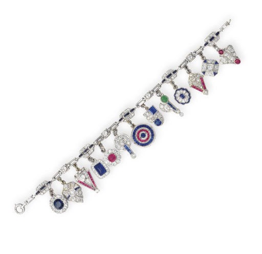 AN ART DECO MULTI-GEM AND DIAMOND CHARM BRACELET