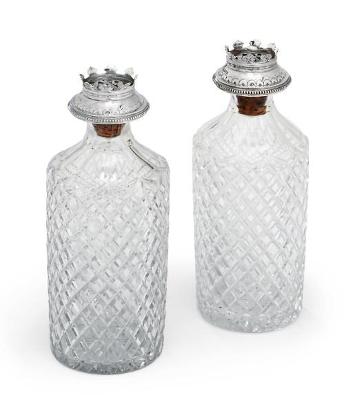 A PAIR OF VICTORIAN SILVER-MOUNTED STOPPERS WITH A PAIR OF CUT-GLASS DECANTERS