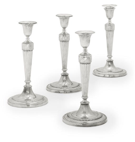 A SET OF FOUR GEORGE III SILVER CANDLESTICKS