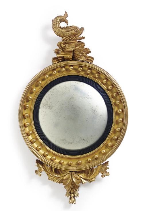 A GILTWOOD AND EBONISED CONVEX MIRROR