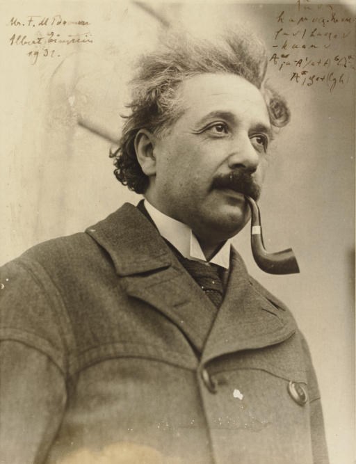 EINSTEIN, Albert. Photograph inscribed and signed ("Albert Einstein"), 1931; ALSO WITH SCIENTIFIC NOTATIONS on top right corner of photo. Black and white glossy photo (8 3/8 x 6½ in.), with margins; slight closed tear on left margin, very slight spotting. [WITH:]: EINSTEIN. Holograph note fragment, unsigned, n.d. Nine lines of mathematical equations. 2 pages, oblong (3½ x 2½ in.), cut from a larger sheet, notations on recto and verso. Also with two unsigned black and white photos of Einstein.