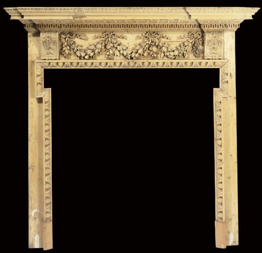 A GEORGE III CARVED PINE CHIMNEYPIECE