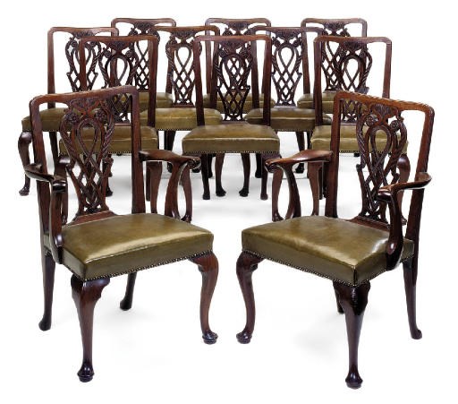 A SET OF ELEVEN MAHOGANY AND GREEN LEATHER UPHOLSTERED DINING CHAIRS