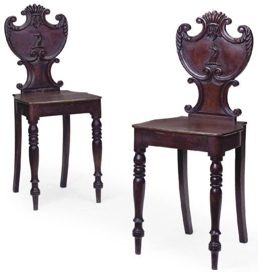 A PAIR OF LATE REGENCY STAINED OAK HALL CHAIRS