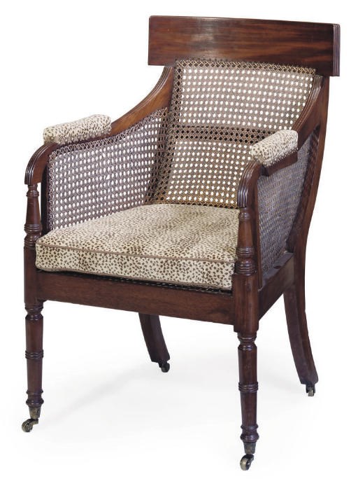 A LATE REGENCY MAHOGANY AND CANED LIBRARY BERGERE