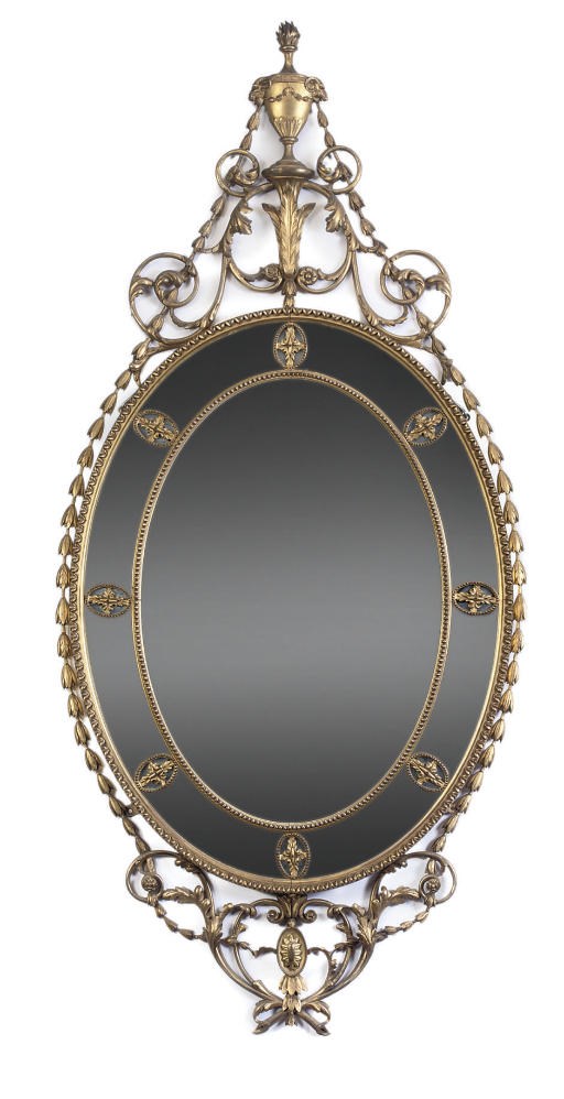 A CARVED AND GILT COMPOSITION MIRROR