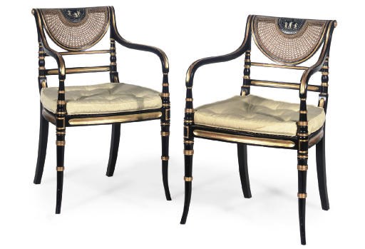 A PAIR OF EBONISED AND GILT ARMCHAIRS