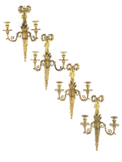 A SET OF FOUR GILT-BRONZE TWIN-LIGHT WALL APPLIQUES