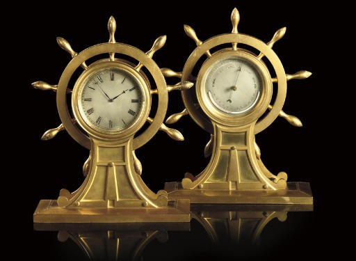 AN EDWARDIAN GILT-BRASS TIMEPIECE AND A BAROMETER