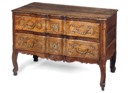 A FRENCH PROVINCIAL WALNUT AND OAK SERPENTINE COMMODE