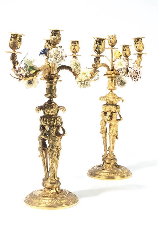A PAIR OF GILT-BRONZE AND PORCELAIN FOUR-LIGHT CANDELABRA