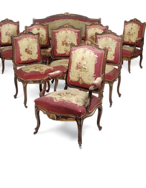 A NAPOLEON III AUBUSSON UPHOLSTERED WALNUT AND PARCEL GILT SALON SUITE