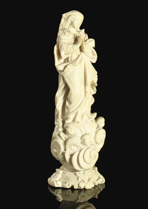 A CARVED IVORY FIGURE OF THE VIRGIN