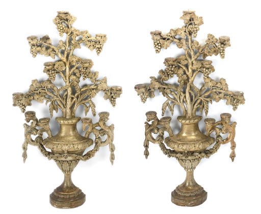 A PAIR OF ITALIAN CARVED GILTWOOD CANDLE STICKS