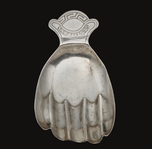 A GEORGE III SILVER HAND CADDY SPOON,