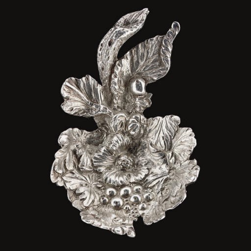 A GEORGE III CAST SILVER CADDY SPOON,