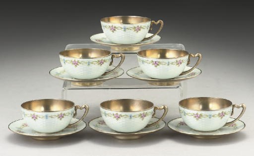 A SET OF SIX CONTINENTAL SILVER-GILT & ENAMEL DEMI-TASSE CUPS & SAUCERS,
