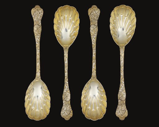 A SET OF FOUR VICTORIAN SILVER-GILT FRUIT-SERVING SPOONS OF STAG HUNT PATTERN,