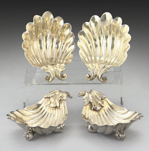 A SET OF FOUR GEORGE III PARCEL-GILT SILVER BUTTER SHELLS,