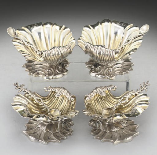 A MATCHED SET OF FOUR WILLIAM IV/VICTORIAN SILVER SHELL SALTS,