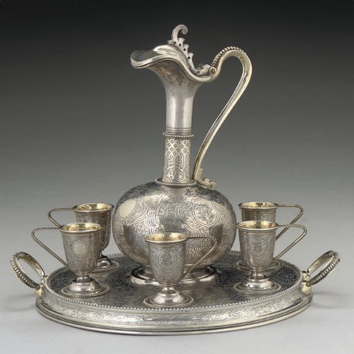 A LATE 19TH CENTURY RUSSIAN PARCEL-GILT SILVER VODKA SET,