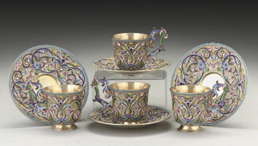 A SET OF FOUR EARLY 20TH CENTURY RUSSIAN SILVER-GILT & SHADED CLOISONNE ENAMEL COFFEE CUPS & SAUCERS,
