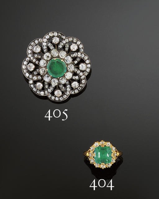 An emerald and diamond cluster ring